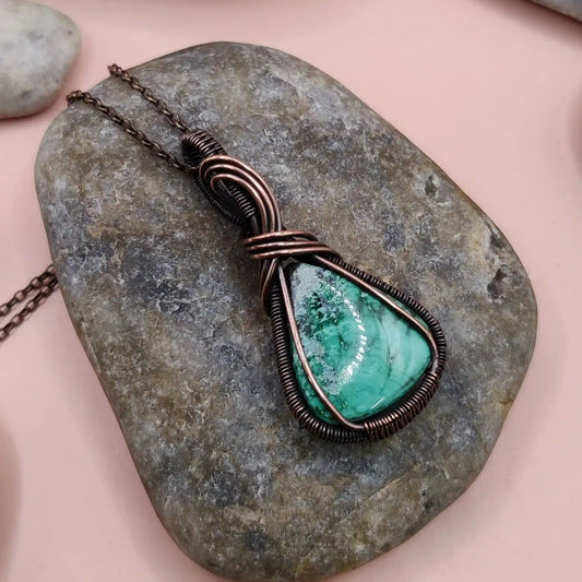 a copper necklace made with natural malachite by sanguine aura handcrafted jewellery india. the copper amplifies the energy of original malachite