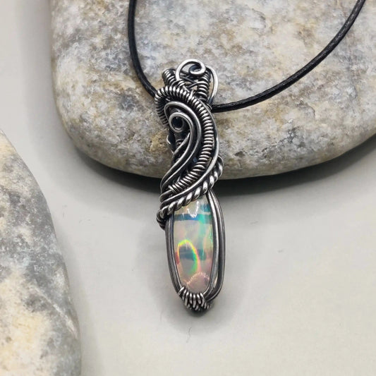 Banno, an Ethiopian opal silver pendant's front view. this pendant has been created by Sanguine Aura.