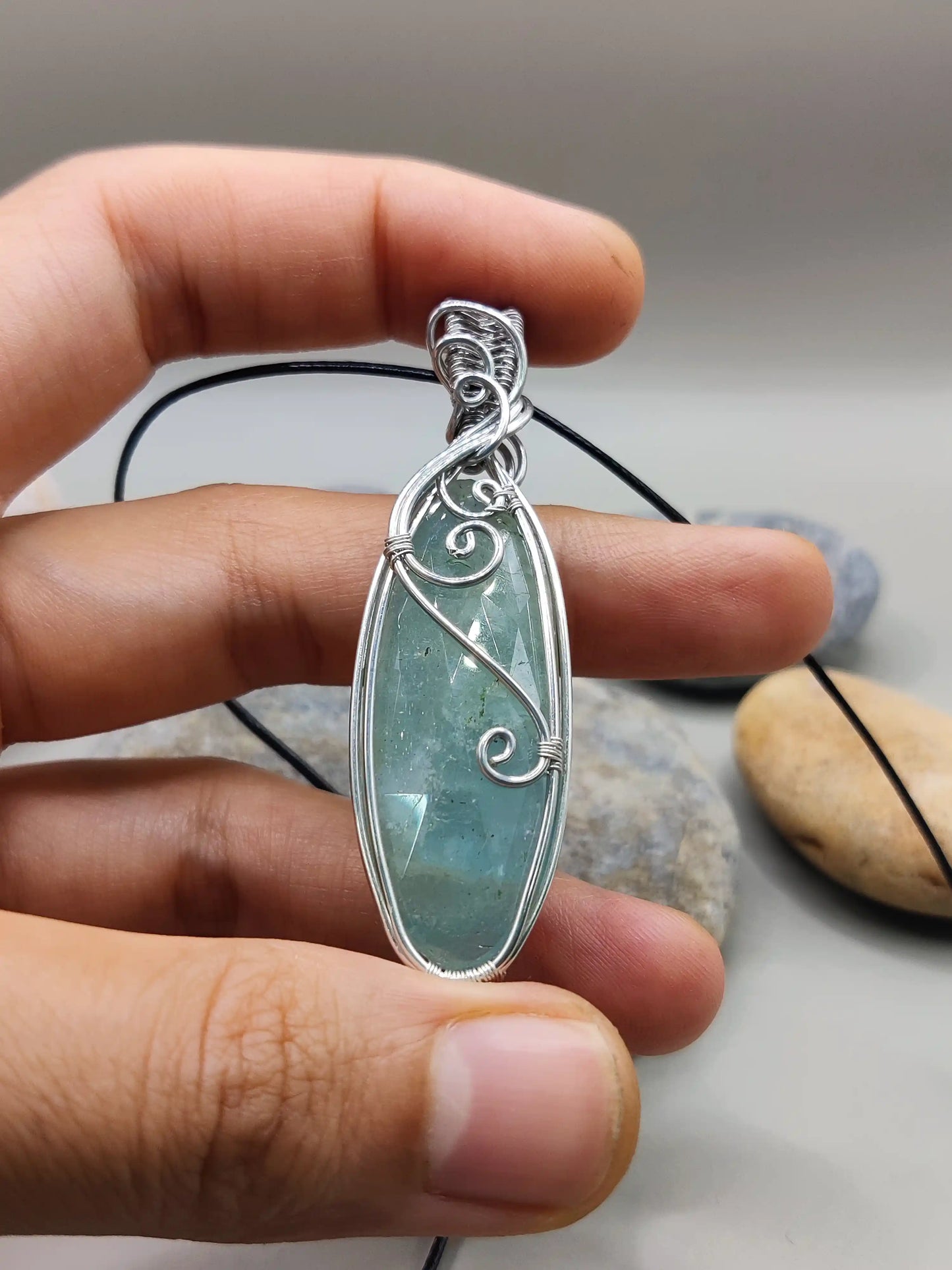 Dakshi- Aquamarine silver pendant's closeup view in hand. Created by Sanguine Aura Handcrafted jewellery