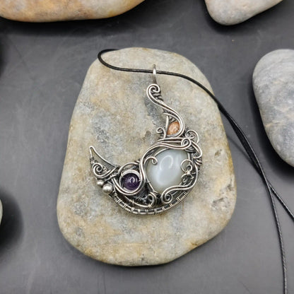 Lusine crescent silver moon pendant with amethyst, white moonstone, and sunstone set in 925 sterling silver handmade by a local artisan.