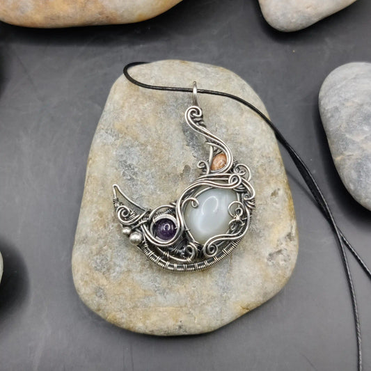 Lusine crescent silver moon pendant with amethyst, white moonstone, and sunstone set in 925 sterling silver handmade by a local artisan.