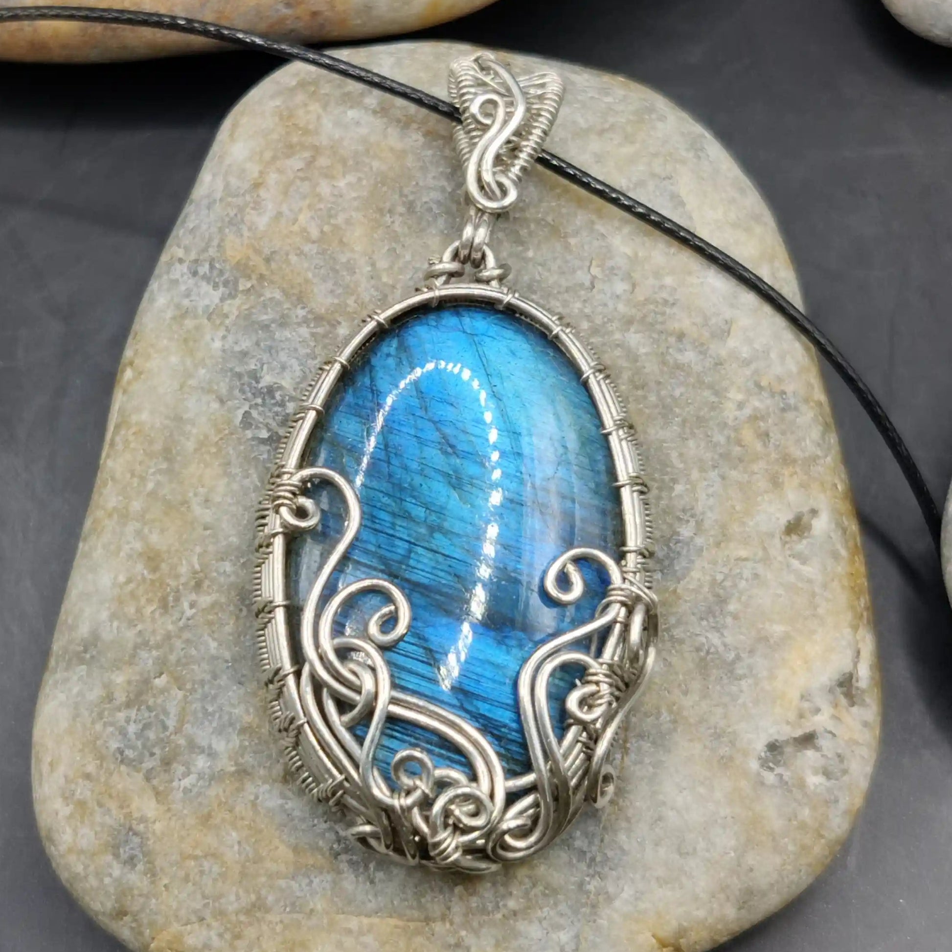Manovriti labradorite silver pendant with elaborate curves and intricate patterns wirewrapped to perfection.