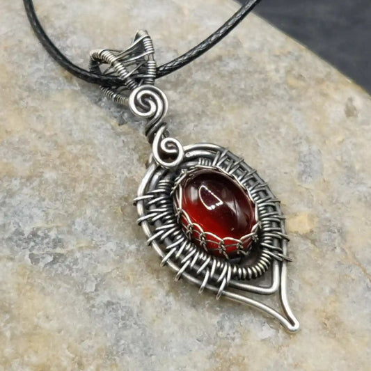 Pallavi Hessonite garnet 925 silver oxidized pendant with fine wirewrapped detailing by sanguine aura