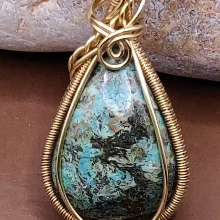 Turquoise pendant necklace on a bed of stones made by sanguine aura handcrafted jewellery, India 