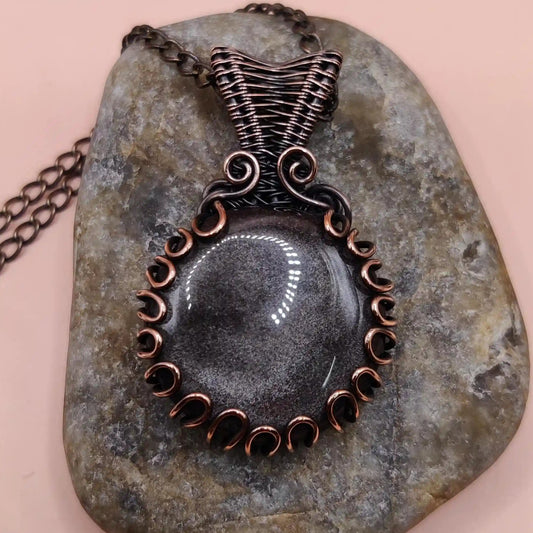surya, a natural black obsidian with silver sheen made into a copper pendant by sanguine aura handcrafted jewellery